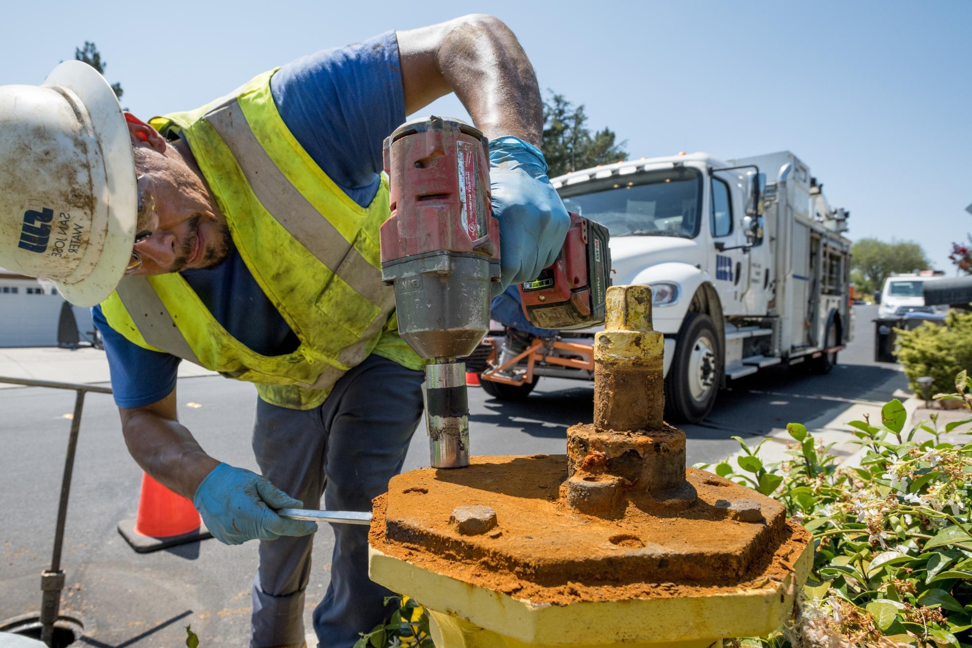 SJW employee fixing fire hydrant